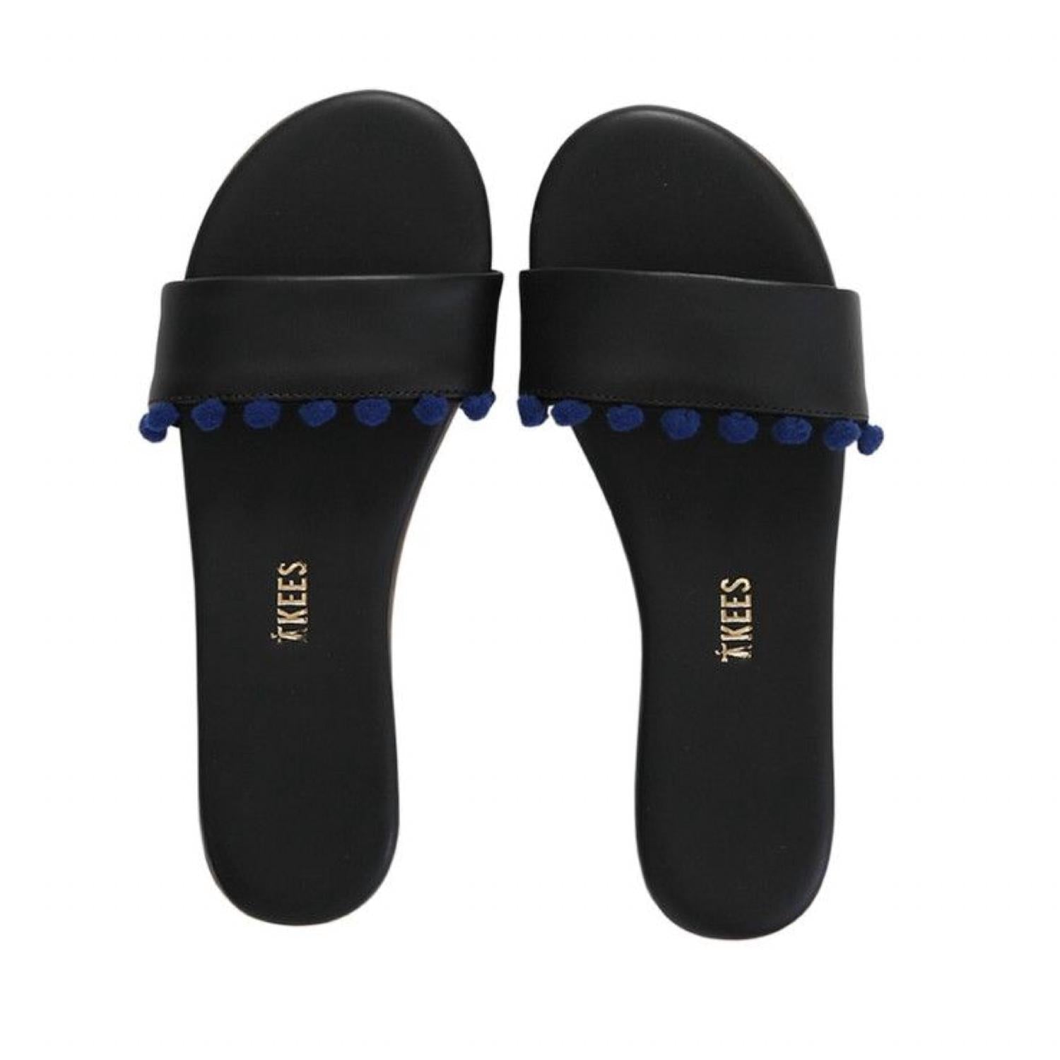 5ae2eda0-a56f-4f98-b7e0-ee85c9a48a51-upscale_15k-1500x1500-1 Tkees - Women's Alex Pom Pom Slide - Image 1